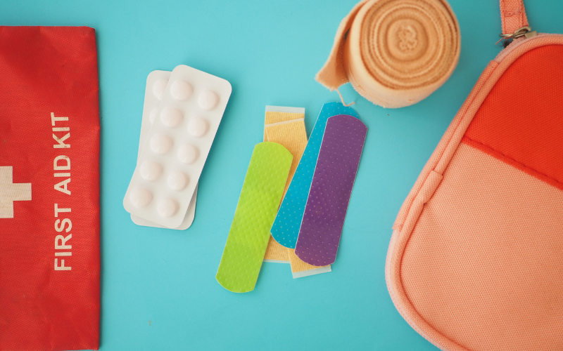 first aid kit with band aids and painkillers