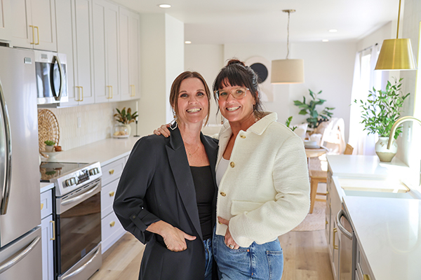 Leslie Davis and Lyndsay Lamb Leslie Davis and Lyndsay Lamb standing in a kitchen
