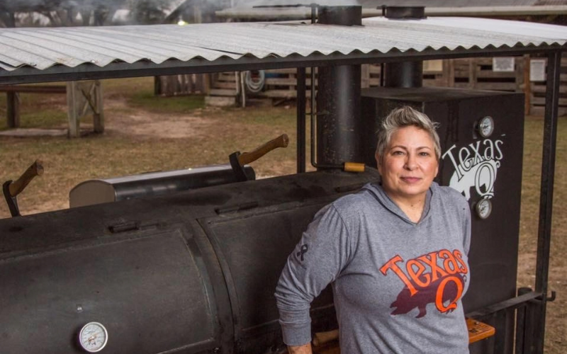 Sloan Rinaldi Sloan Rinaldi leaning against large smoker at TExas Q