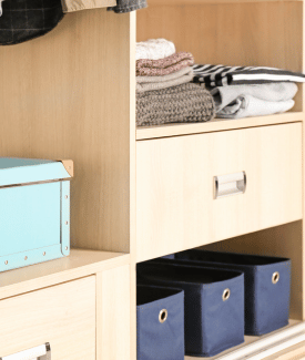 Organized folded towels and shoe boxes in cupboard