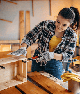 Girl learning to saw and DIY on tool box