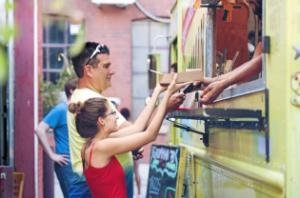 Woman getting food from food truck