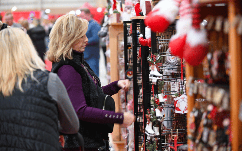 Two blonde female shoppers shopping for Christmas Ornaments at the Des Moines Holiday Boutique