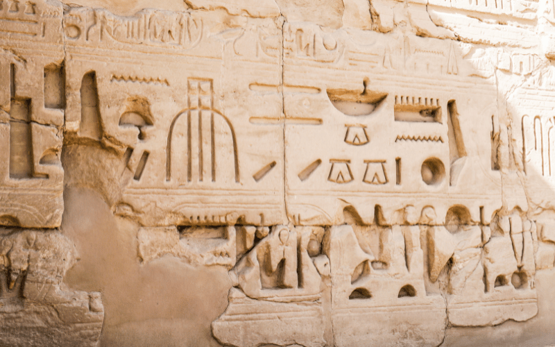 Gift giving hieroglyphs depicting Egyptian customs showing tools gift giving and clothing