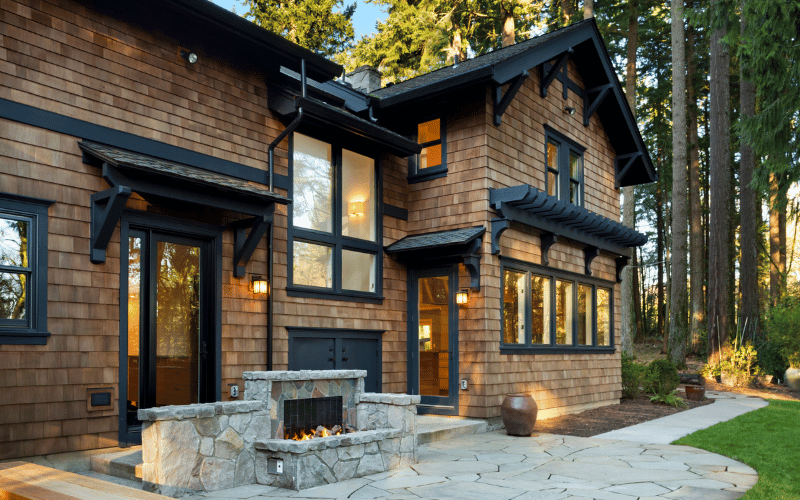 Exterior of newly renovated light brown brick house with fire pit