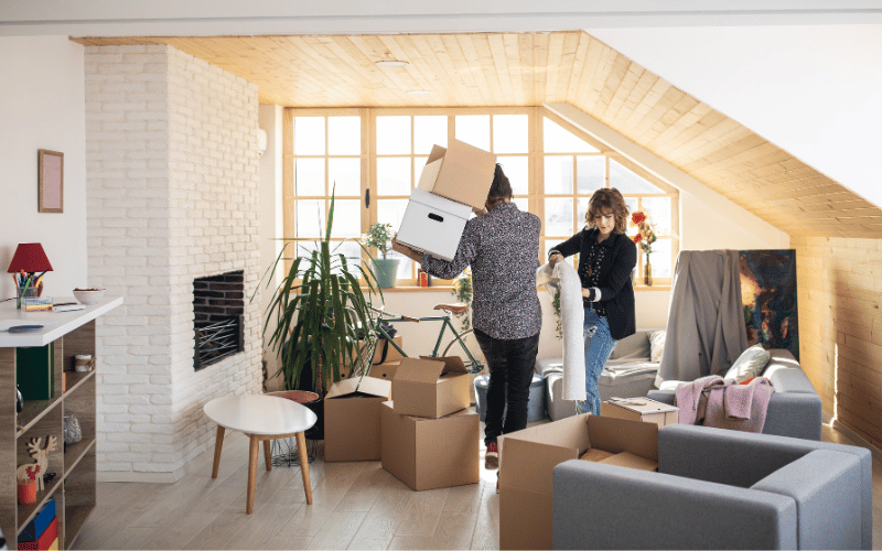 Man and women packing boxes and decluttering their home