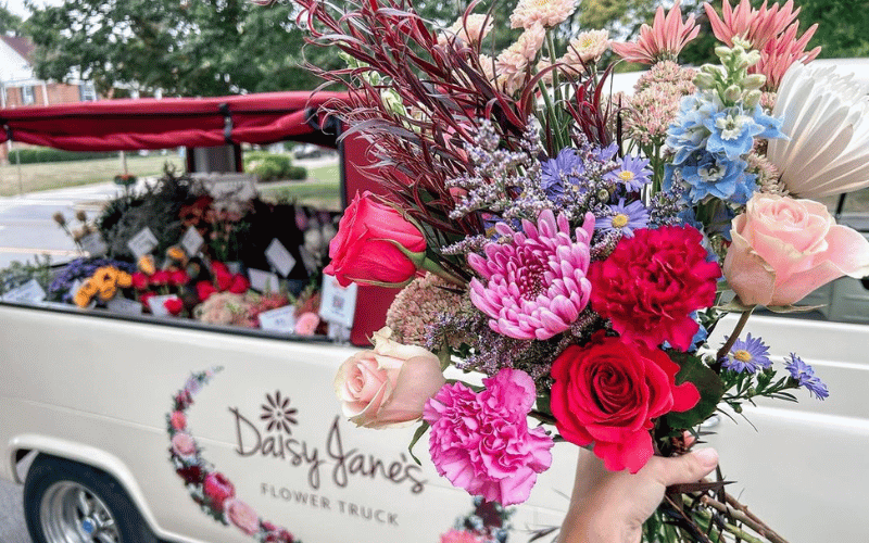 1961 white Ford Econoline with a bouquet of beautiful flowers in a hand