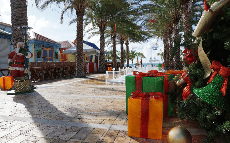 Florida coastal strip decorated for Christmas with giant green and yellow gifts and a santa by palm trees