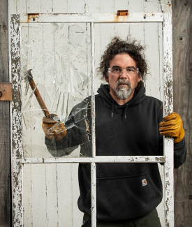 Ryan Elderidge Ryan Elderidge knocking out glass wearing gloves in the midst of a renovation