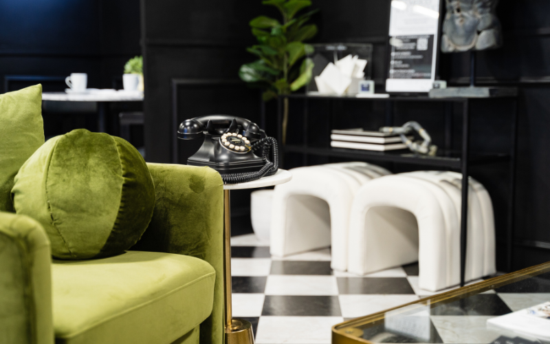 Unused Spaces - Green Velvet Chair and Antique Rotary Phone Unused Spaces - Green Velvet Chair and Antique Rotary Phone and Interior Designed Furniture on Display
