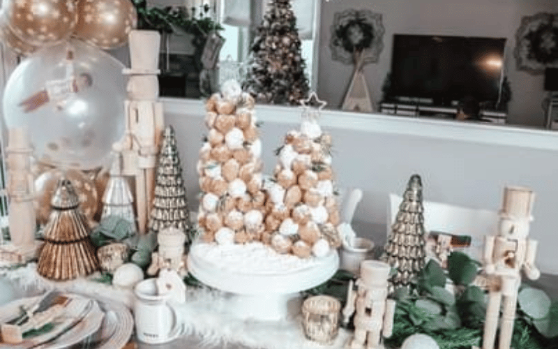 a table with Christmas decor on it including silver trees and nutcrackers 