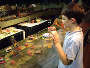 Child looking at train set
