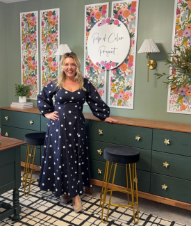 Alissa from Pop Of Color Standing next to Green Floral themed wall and drawerse