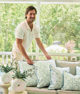 Craig Conover in living room with spring pillow collection