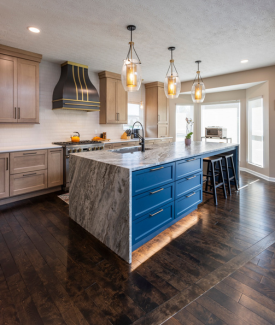 Modern Kitchen Island with bright blue painted drawers and black and white granite countertop