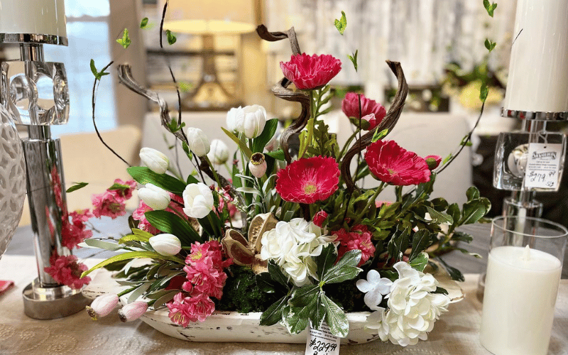 Pink and white florals on decorated modern tablescape with white glass candles